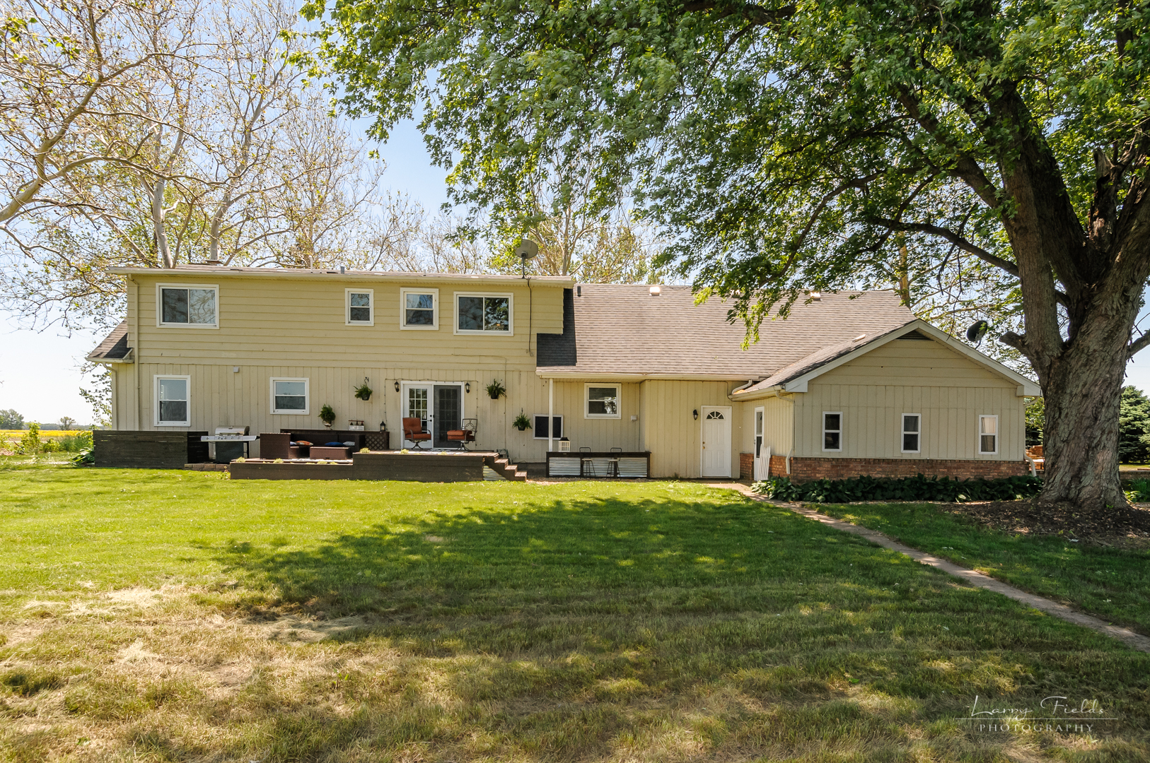 14725 Sears Road Plano, IL 60545 - Photo 19 of 26 a view of a yard with a house and a large tree
