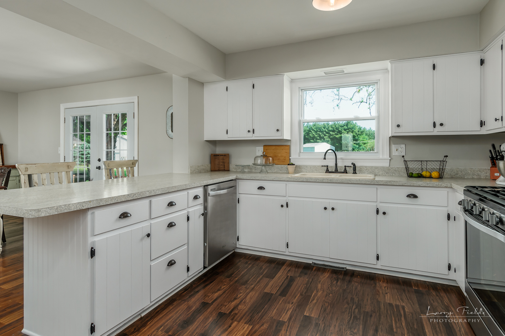 14725 Sears Road Plano, IL 60545 - Photo 7 of 26 a kitchen with white cabinets white stainless steel appliances and sink