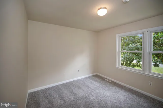 a view of hallway with wooden floor