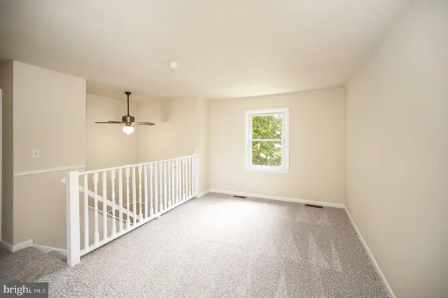 a view of a big room with windows and entryway