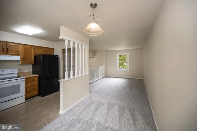 a kitchen with a sink stove top oven and cabinets