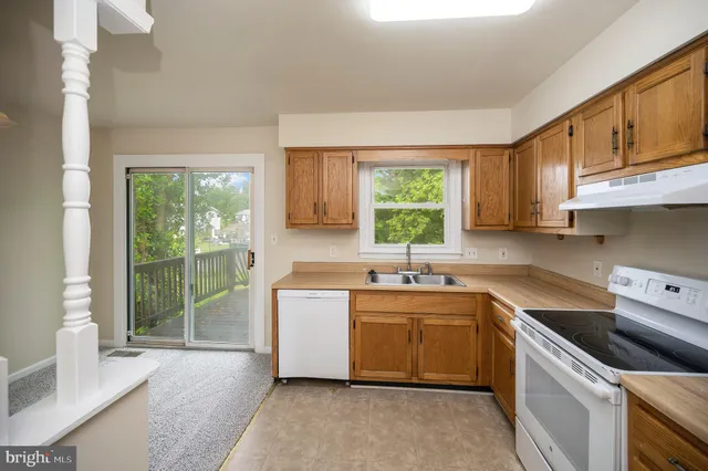 a kitchen with a sink cabinets appliances and a window