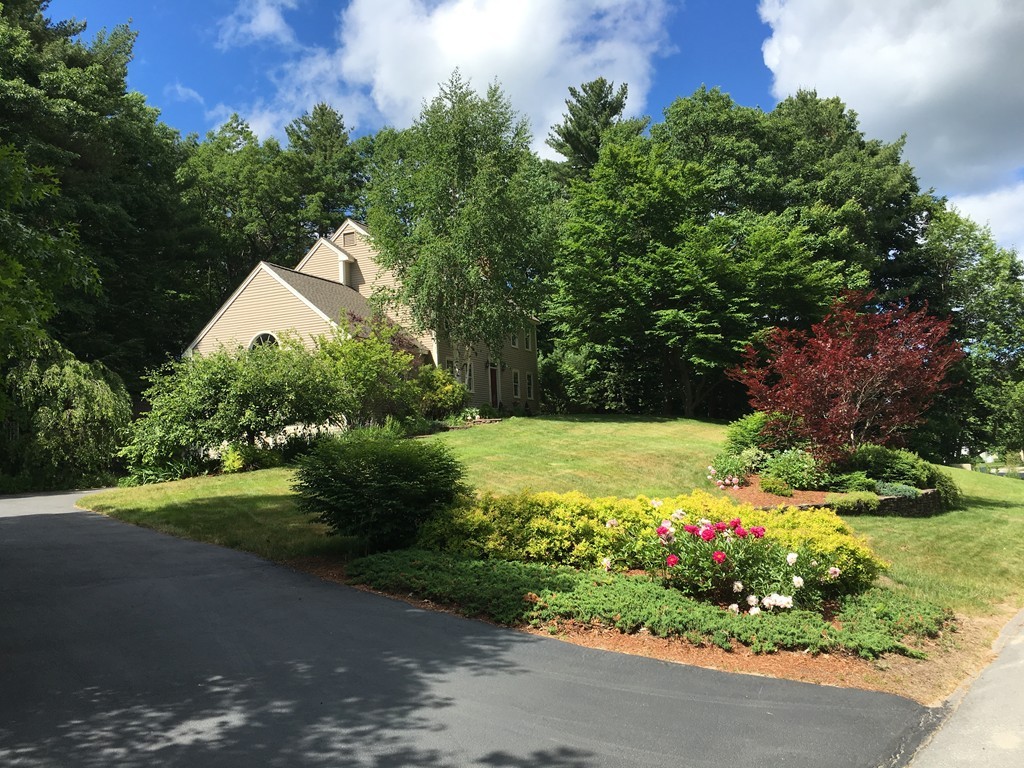 134 Kettle Hole Road Bolton, MA 01740 - Photo 2 of 29 a view of a garden with flowers and trees