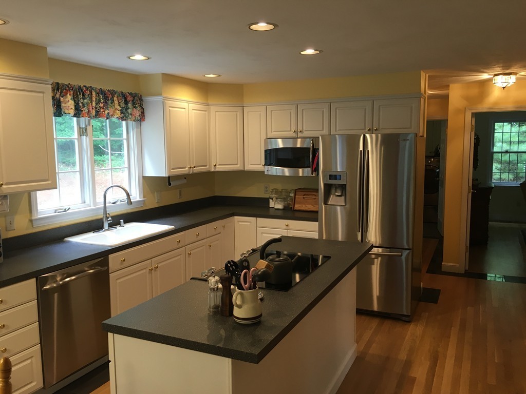 134 Kettle Hole Road Bolton, MA 01740 - Photo 4 of 29 a kitchen with a sink stove and refrigerator
