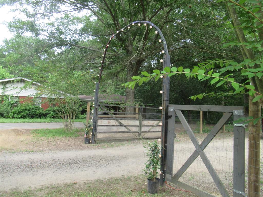 24133 Highway 157 Springhill, LA 71075 - Photo 3 of 19 Gated entrance featuring a decorative archway with integrated lighting