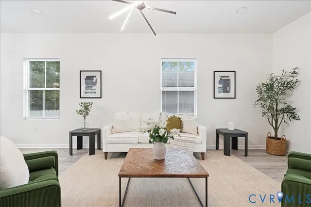 a living room with furniture potted plant and a window
