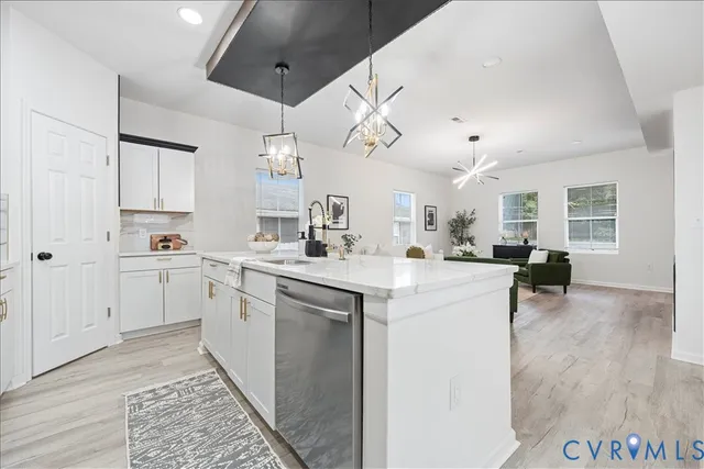a kitchen with cabinets a sink and appliances