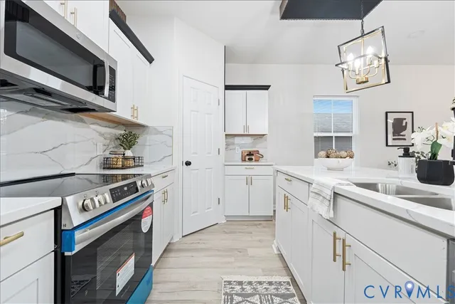 a kitchen with stainless steel appliances granite countertop a stove and a sink