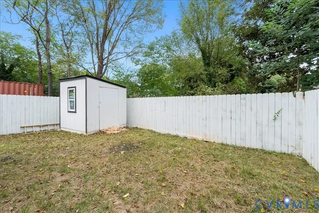 a view of house with backyard and deck