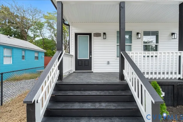 a view of entryway with wooden floor and stairs