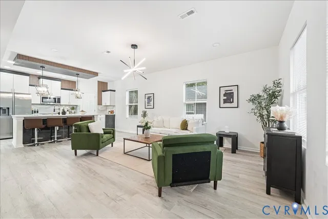 a living room with furniture and wooden floor