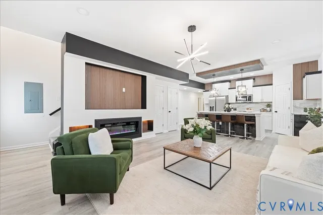 a living room with furniture and a chandelier