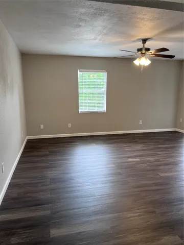 a view of room with window and wooden floor