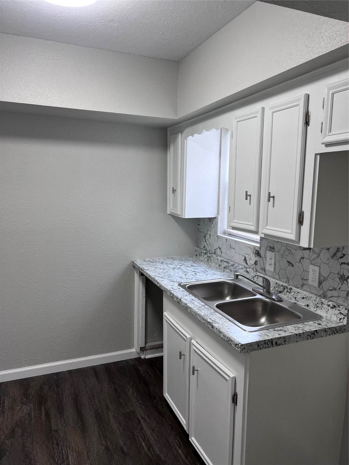 503 Park Lane, Unit 3 Cleveland, TX 77327 - Photo 4 of 5 a kitchen with a sink and cabinets