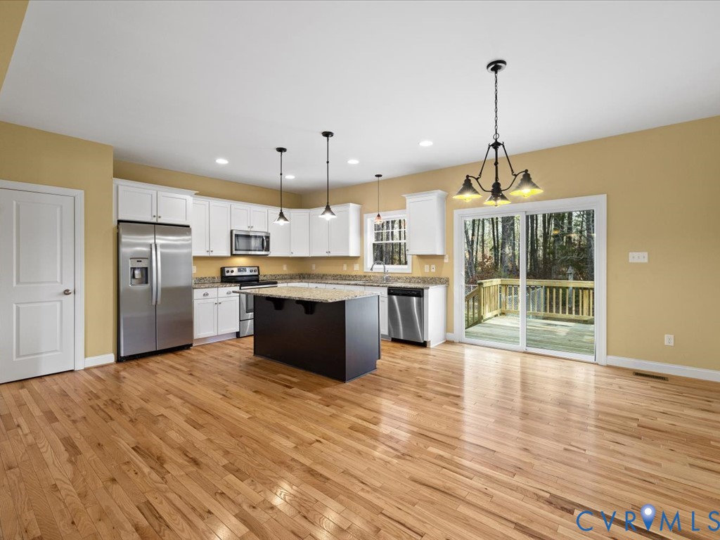2806 Perkinsville Road Maidens, VA 23102 - Photo 11 of 38 a view of kitchen with refrigerator stove and wooden floor