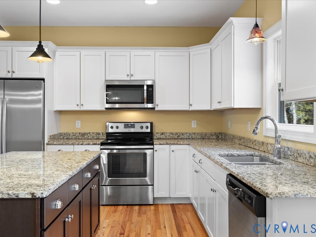 2806 Perkinsville Road Maidens, VA 23102 - Photo 12 of 38 a kitchen with granite countertop a sink a stove and cabinets