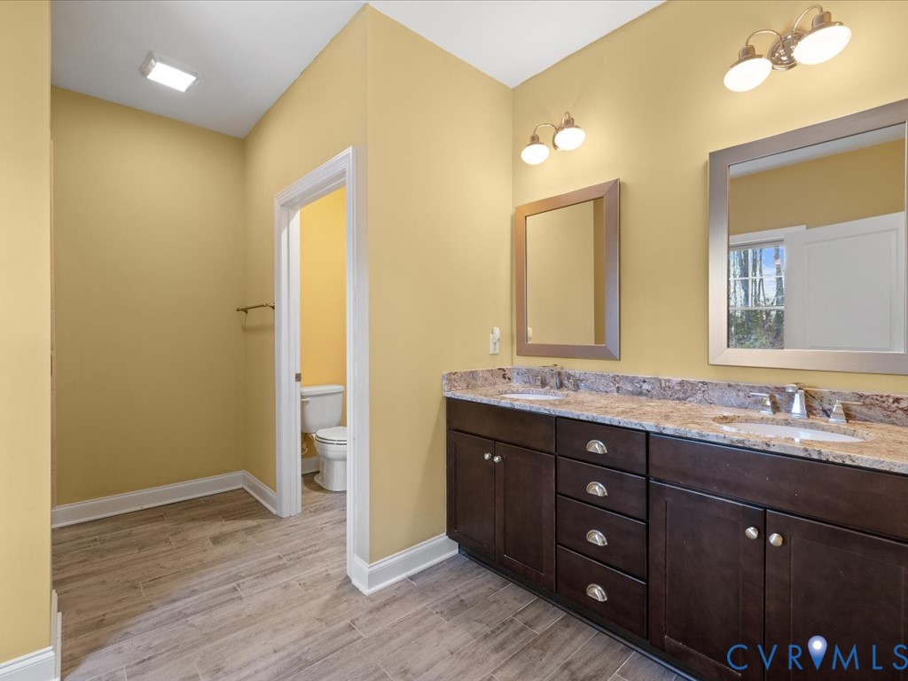 2806 Perkinsville Road Maidens, VA 23102 - Photo 19 of 38 a bathroom with a granite countertop sink and a mirror