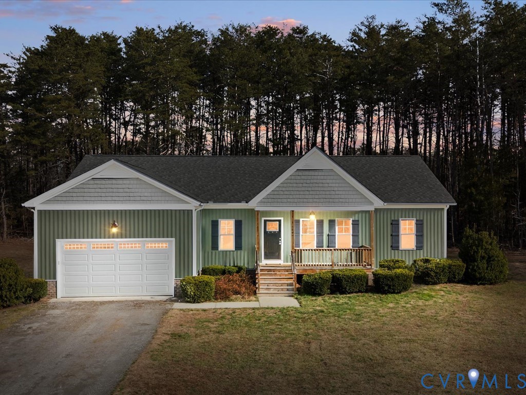 2806 Perkinsville Road Maidens, VA 23102 - Photo 2 of 38 a front view of a house with a yard and garage