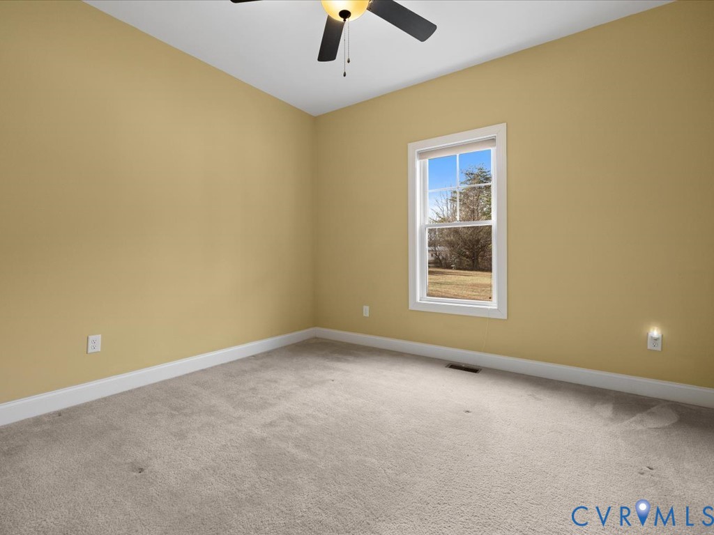 2806 Perkinsville Road Maidens, VA 23102 - Photo 23 of 38 an empty room with a window and a ceiling fan