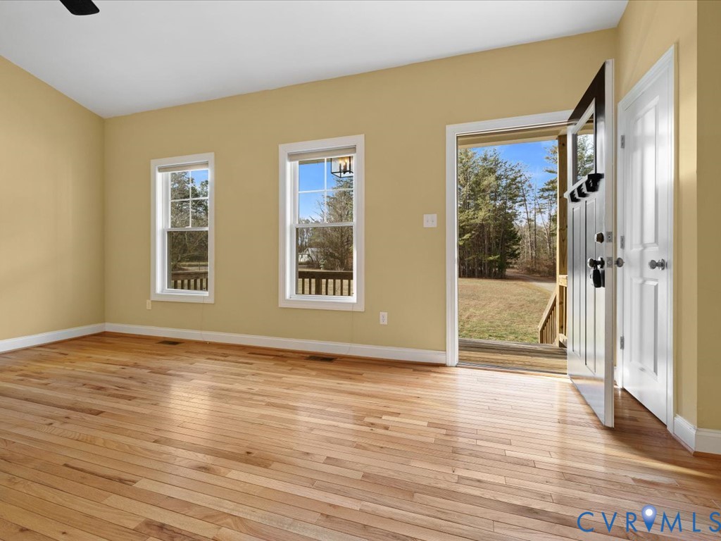 2806 Perkinsville Road Maidens, VA 23102 - Photo 6 of 38 a view of an empty room with wooden floor and a window