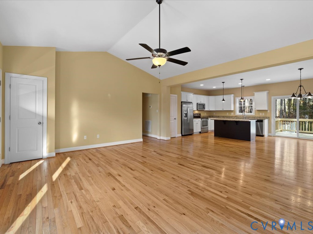 2806 Perkinsville Road Maidens, VA 23102 - Photo 8 of 38 a view of a livingroom with a fireplace a ceiling fan and wooden floor