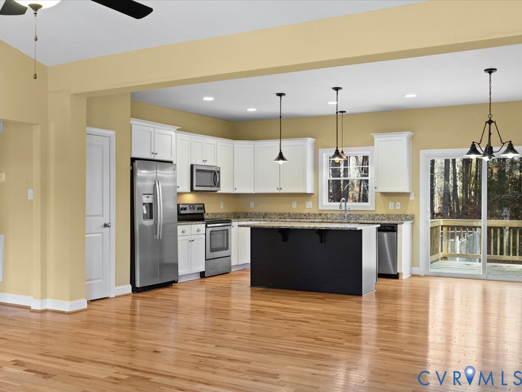 2806 Perkinsville Road Maidens, VA 23102 - Photo 9 of 38 a large kitchen with stainless steel appliances kitchen island a large counter top and wooden floors