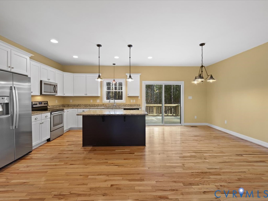 2806 Perkinsville Road Maidens, VA 23102 - Photo 10 of 38 a large kitchen with stainless steel appliances granite countertop a stove a sink dishwasher a refrigerator and a oven with wooden floor
