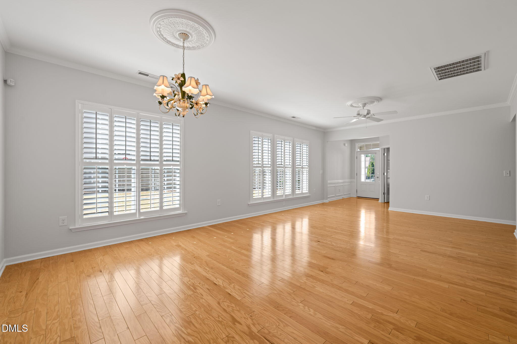 555 Tomkins Loop Cary, NC 27519 - Photo 10 of 50 a view of an empty room with a window and wooden floor