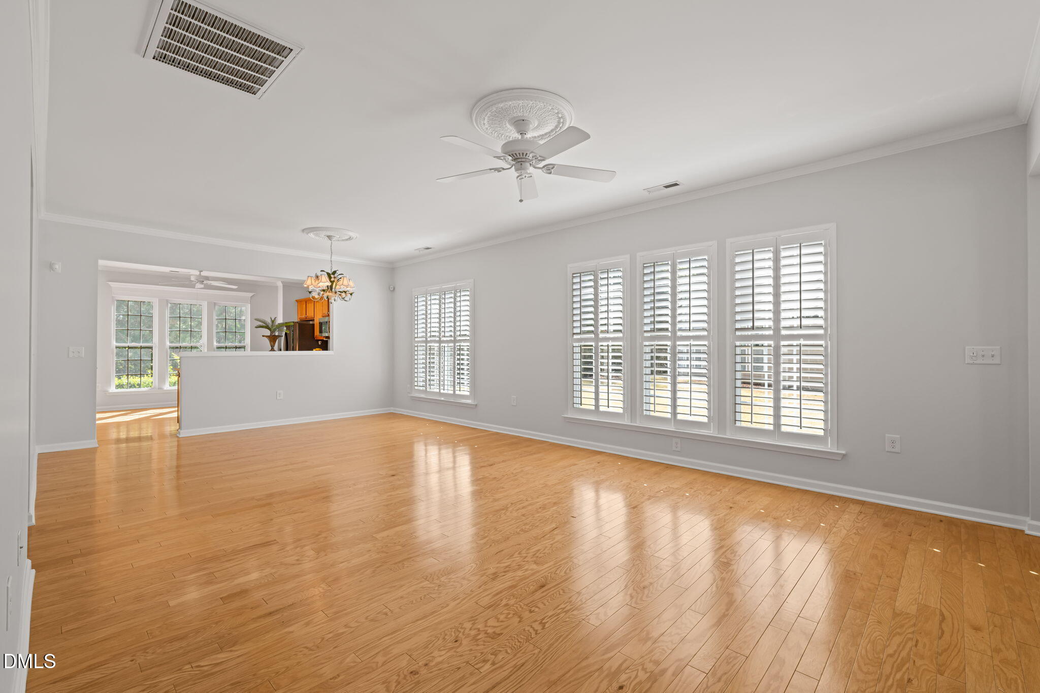 555 Tomkins Loop Cary, NC 27519 - Photo 13 of 50 a view of an empty room with a window and wooden floor
