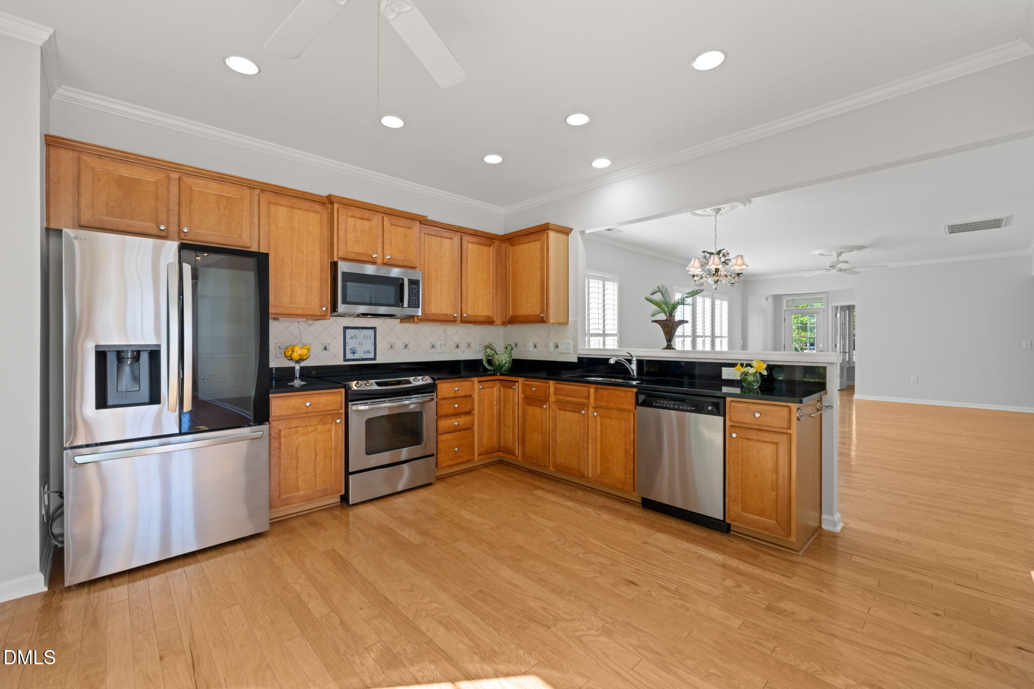 555 Tomkins Loop Cary, NC 27519 - Photo 15 of 50 a kitchen with stainless steel appliances granite countertop a refrigerator a sink dishwasher a stove and a microwave oven on granite countertops