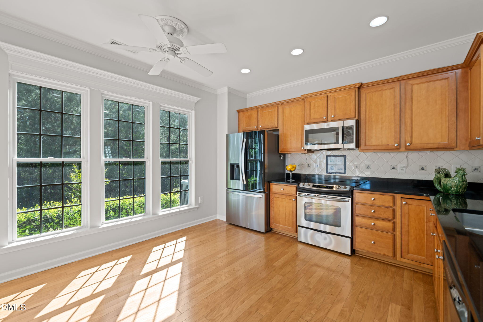 555 Tomkins Loop Cary, NC 27519 - Photo 16 of 50 a kitchen with stainless steel appliances granite countertop a stove a sink and a refrigerator