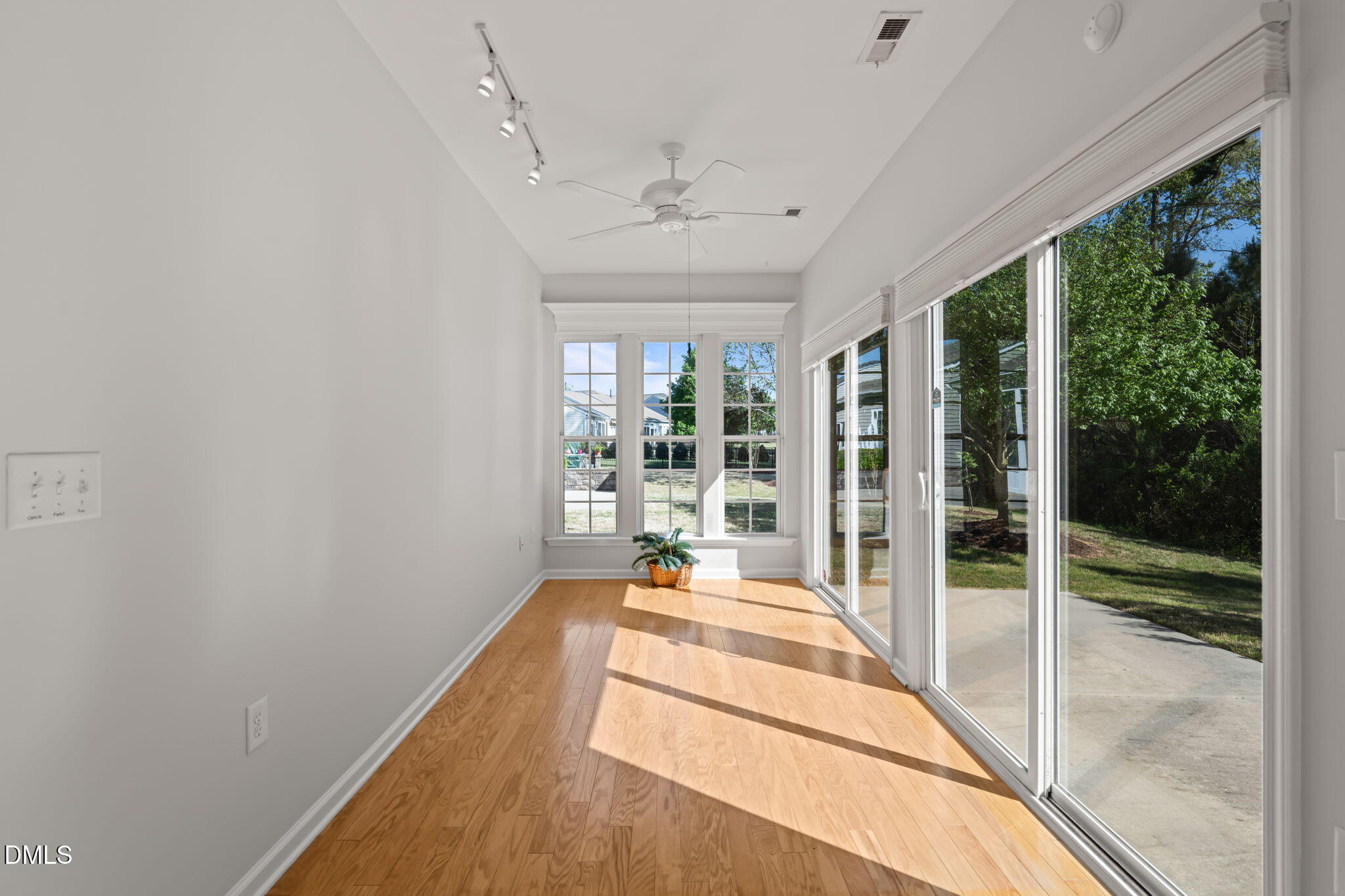 555 Tomkins Loop Cary, NC 27519 - Photo 19 of 50 a bedroom with a bed and large windows