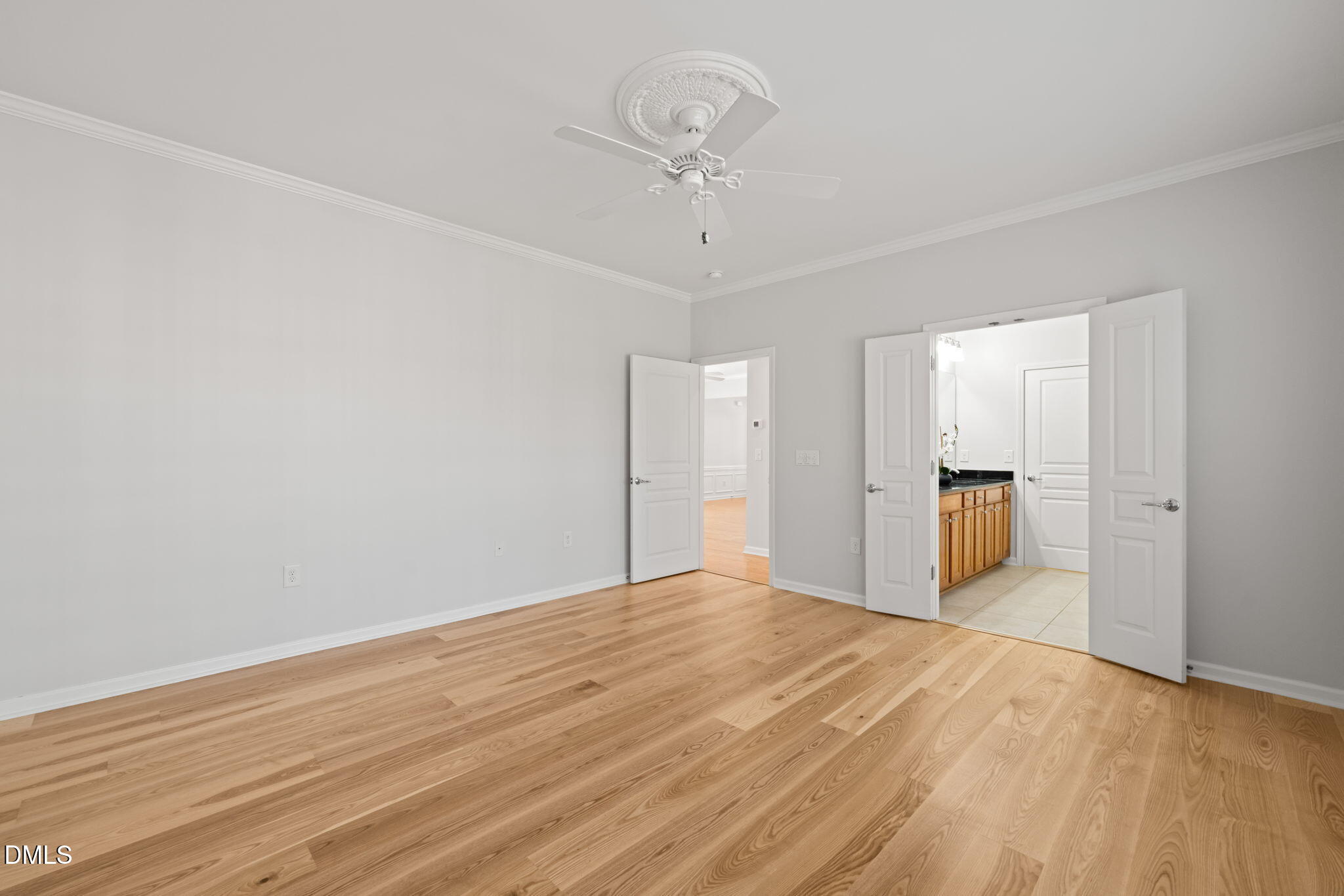 555 Tomkins Loop Cary, NC 27519 - Photo 22 of 50 a view of a room with wooden floor and a ceiling fan