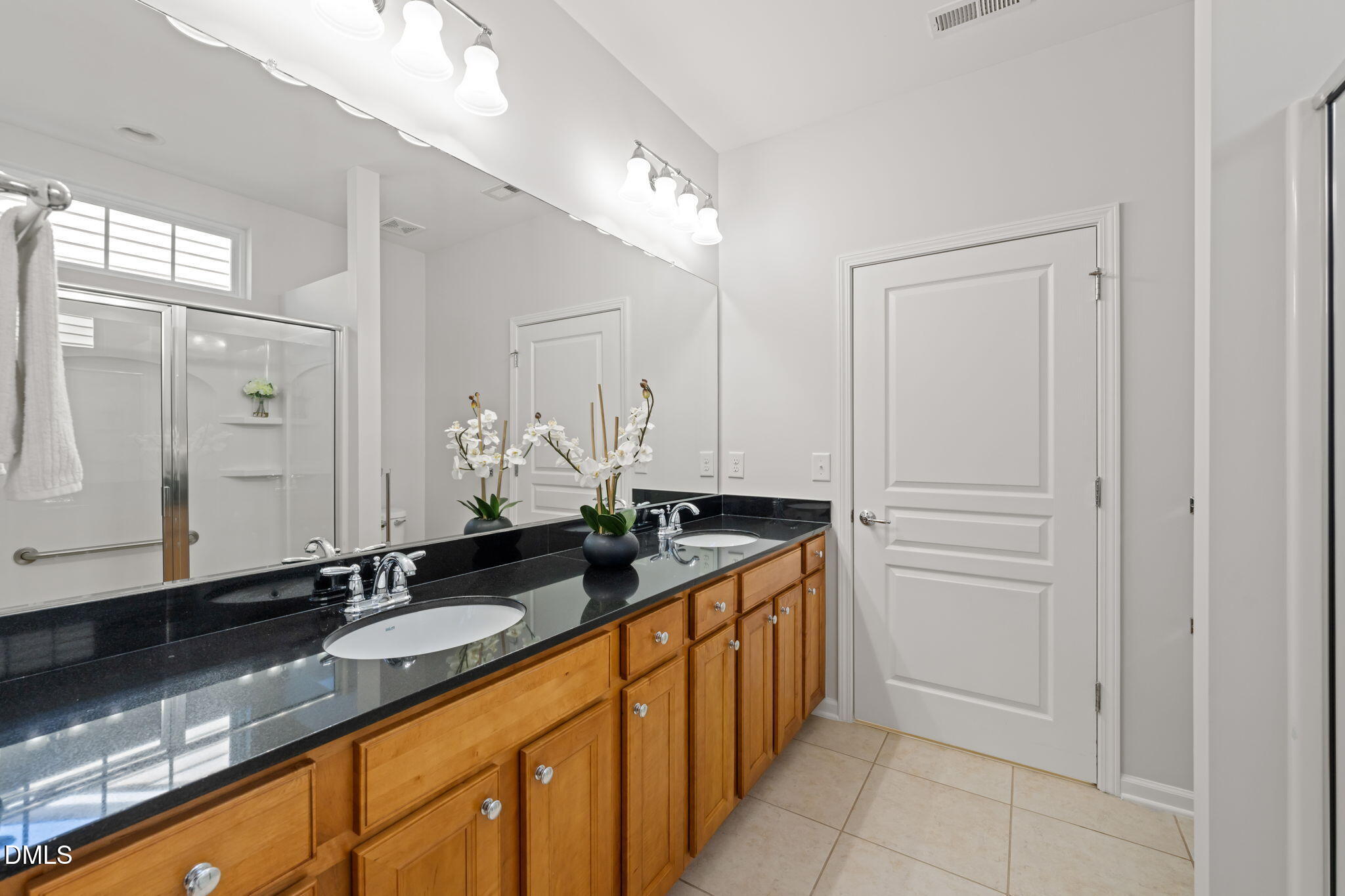 555 Tomkins Loop Cary, NC 27519 - Photo 24 of 50 a bathroom with a granite countertop sink and a mirror
