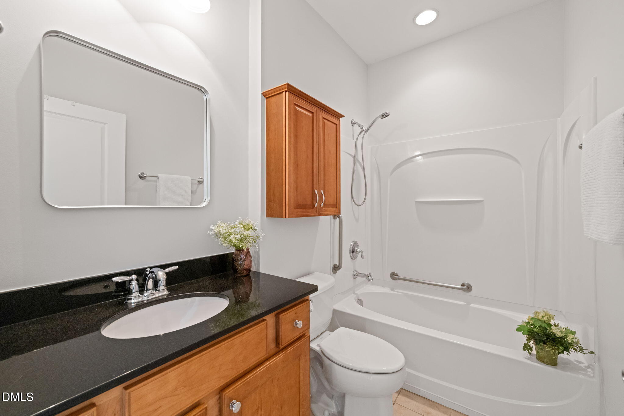 555 Tomkins Loop Cary, NC 27519 - Photo 31 of 50 a bathroom with a granite countertop sink toilet mirror and bathtub