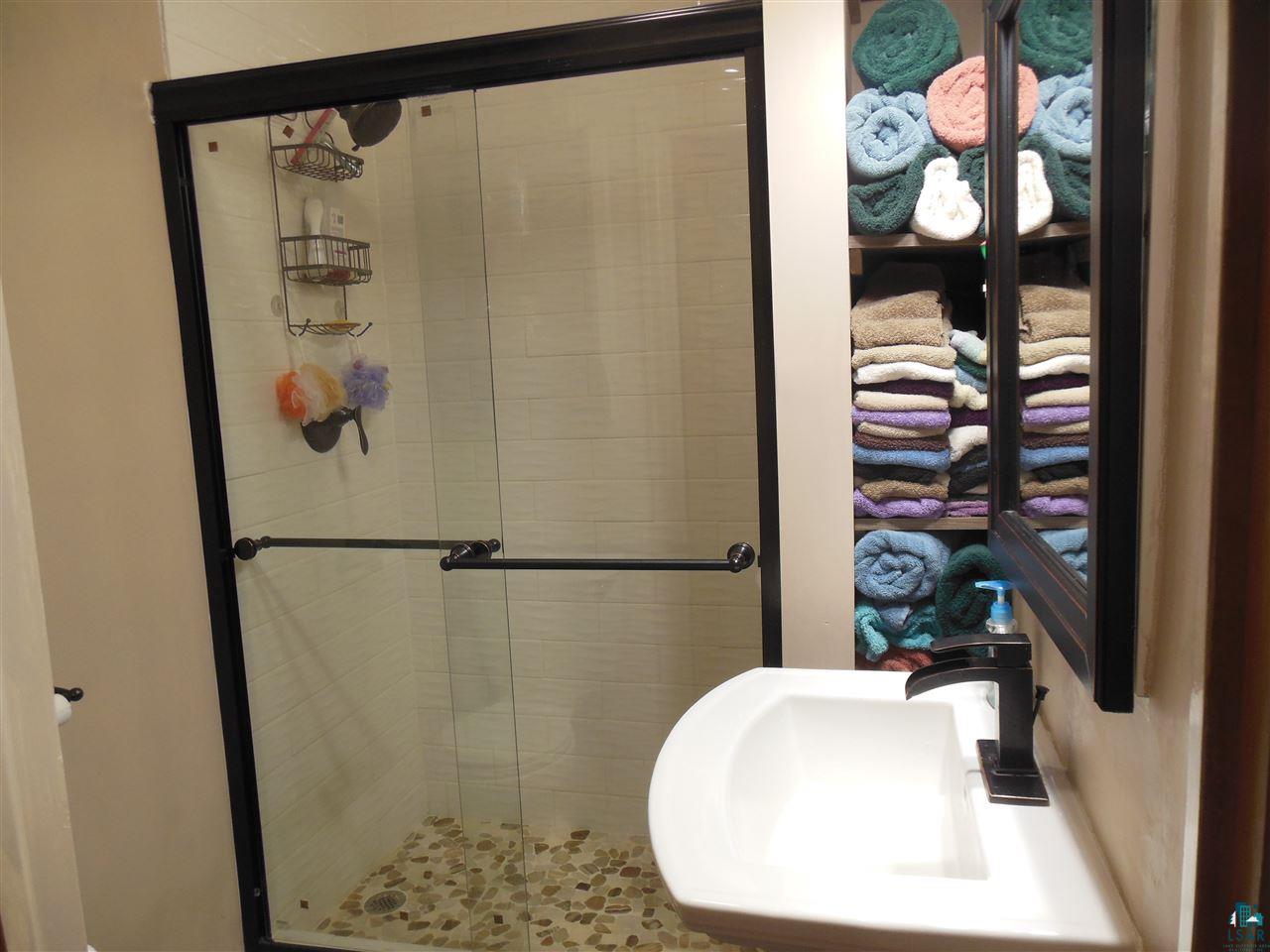 585 Center Road Wright, MN 55798 - Photo 18 of 24 Totally remodeled in 2017! Pedestal sink, beautiful shower and towel nook cupboard