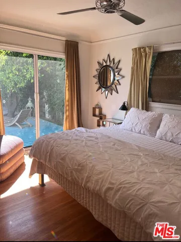 a bedroom with a bed and a large window