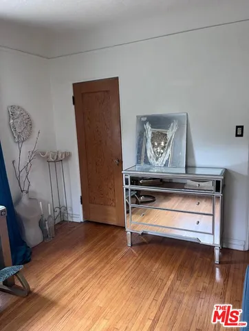 a view of room with furniture and wooden floor