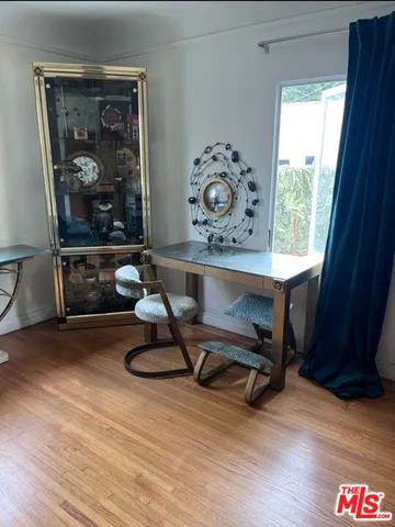 a view of workspace with a window and wooden floor