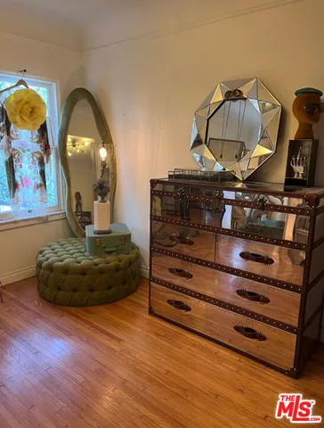 a bedroom with a bed and a mirror