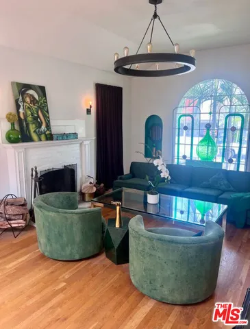 a view of living room with furniture and a fireplace