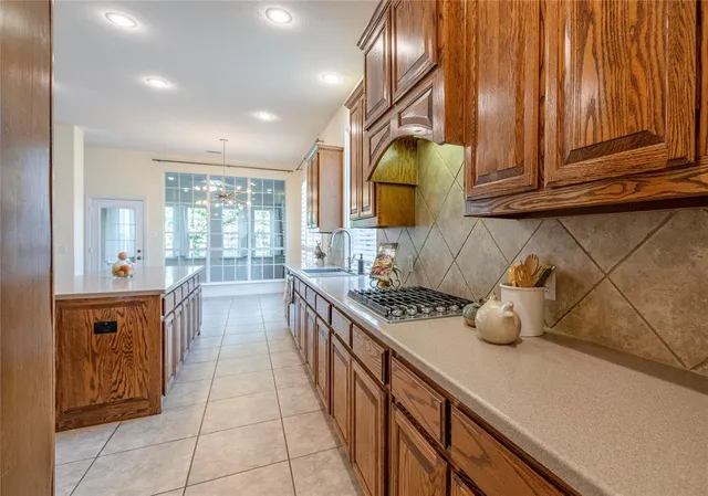 a kitchen with stainless steel appliances granite countertop a sink and cabinets