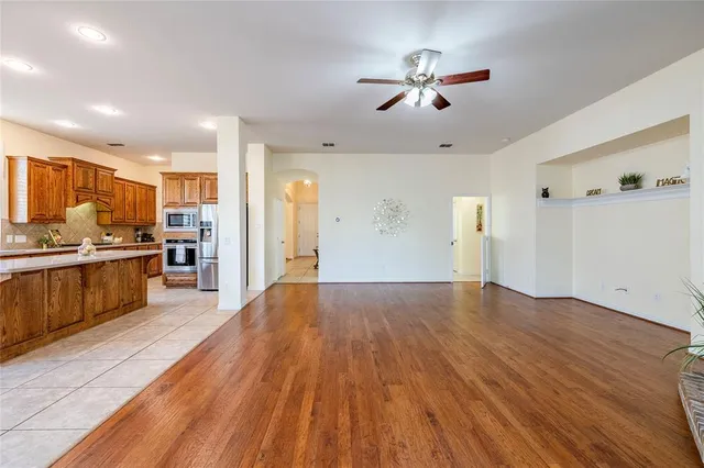 a view of kitchen with refrigerator microwave and stove