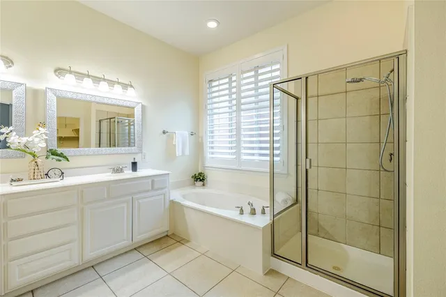 a bathroom with a tub sink shower and mirror