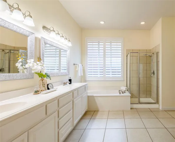 a bathroom with a tub sink and mirror