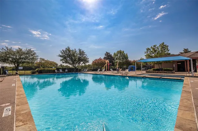 a view of a swimming pool with a yard