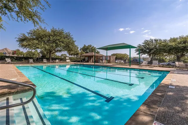 a view of a backyard with swimming pool