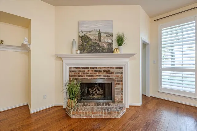 a living room with a fireplace and a wooden floor