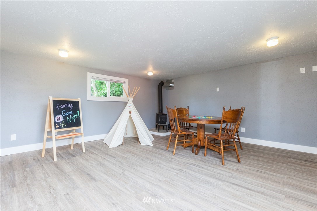 634 Ferndale Place Northeast Renton, WA 98056 - Photo 16 of 25 a view of a dining room with furniture and wooden floor