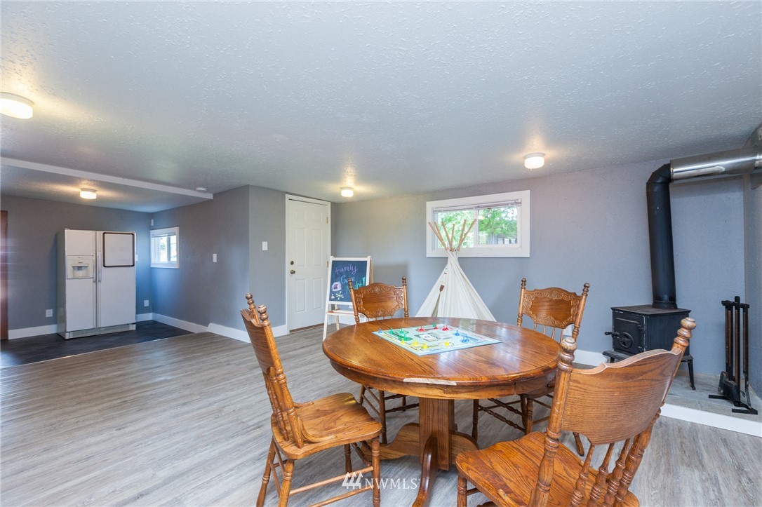 634 Ferndale Place Northeast Renton, WA 98056 - Photo 17 of 25 a dining room with furniture and wooden floor